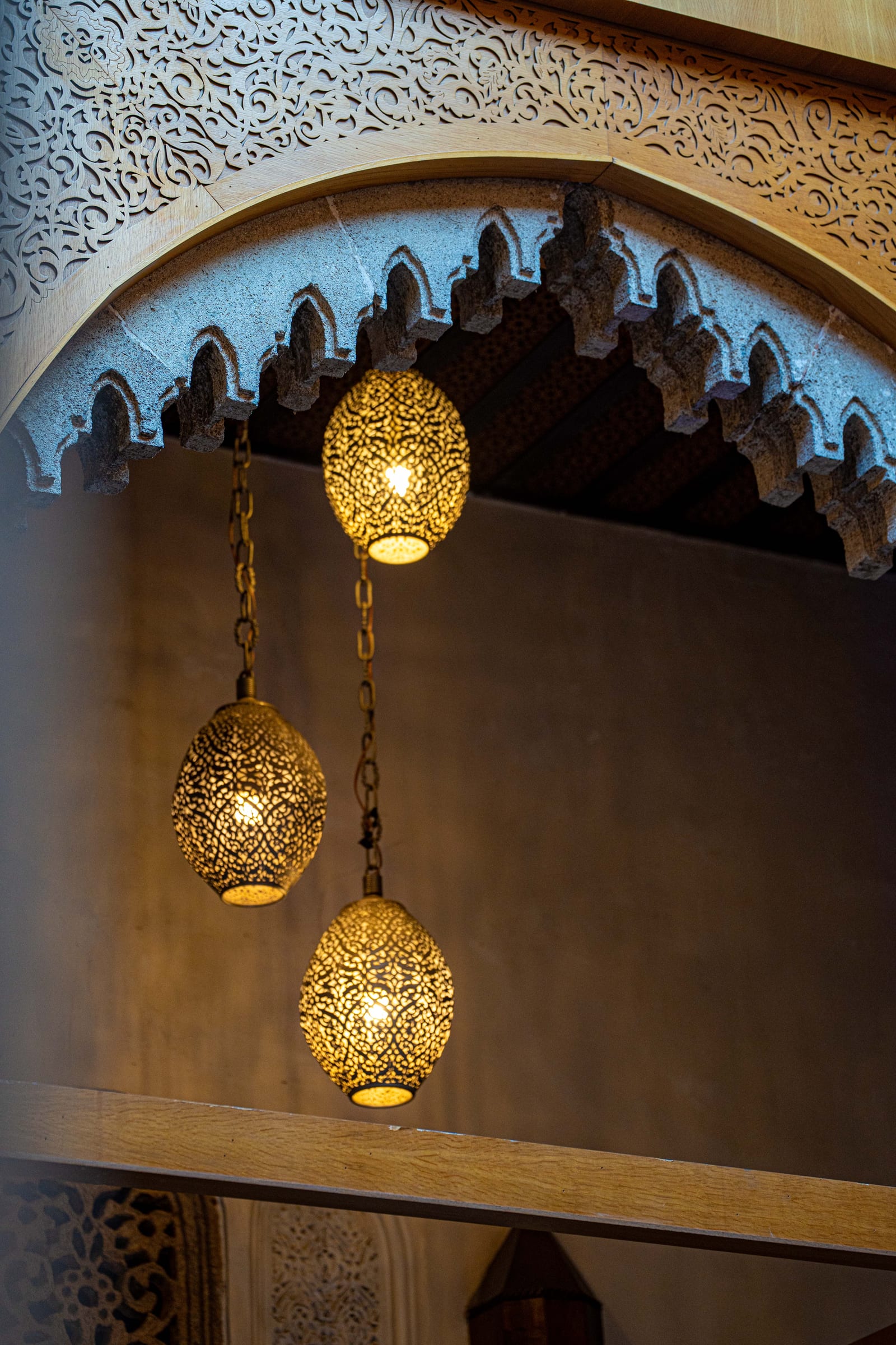 Architectural detail of carved arches and lanterns